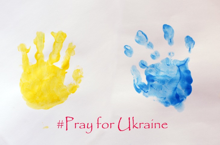 Child's handprints symbolizing Ukrainian flag
